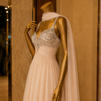 Mannequin wearing a beaded evening gown with a long train in a store setting