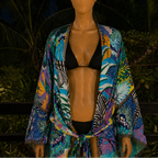 Mannequin wearing a colorful robe with tropical patterns against a dark background