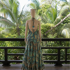 Mannequin wearing a patterned dress with a tropical background