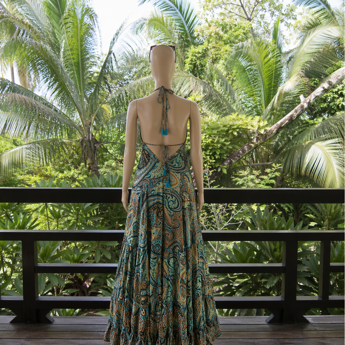 Mannequin wearing a patterned dress with a tropical background